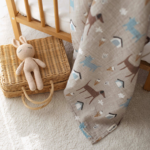 Close-up of dog park swaddle next to a wicker basket