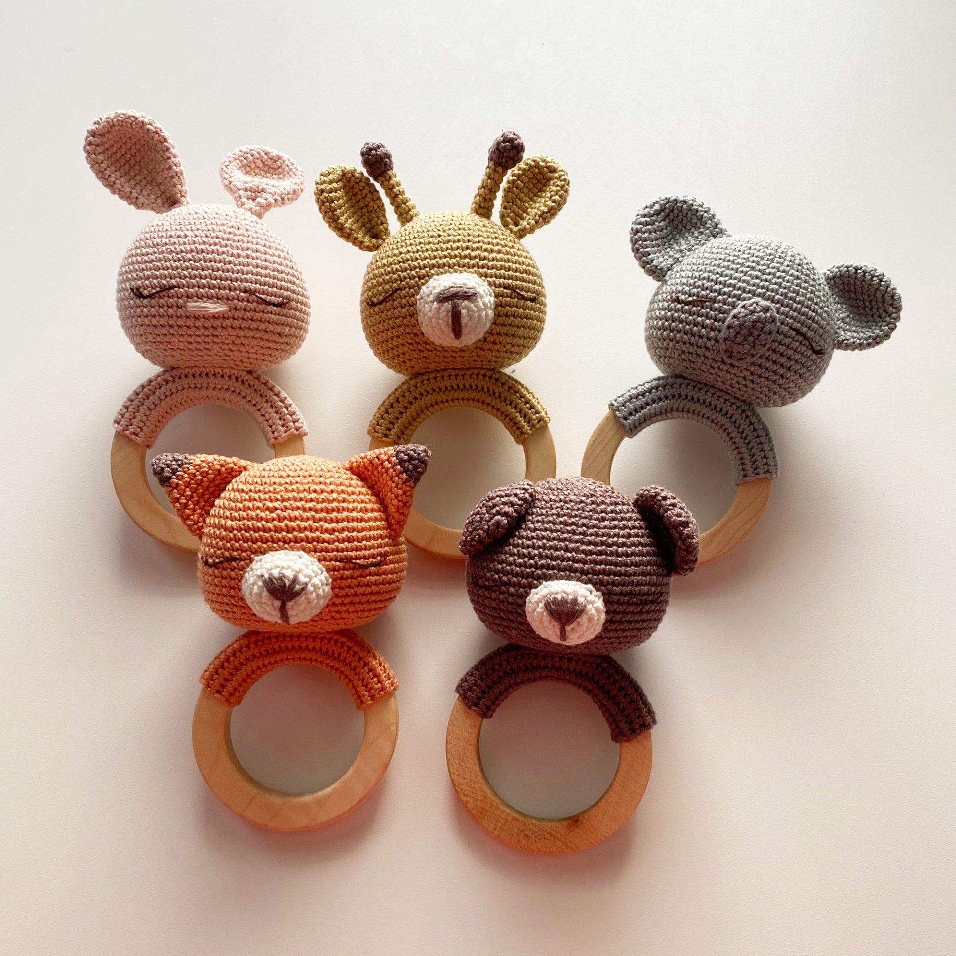 Group of crocheted animal teething rattles including deer, bear, and bunny