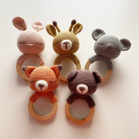 Set of handmade crochet animal teethers including bear, bunny, koala, and fox