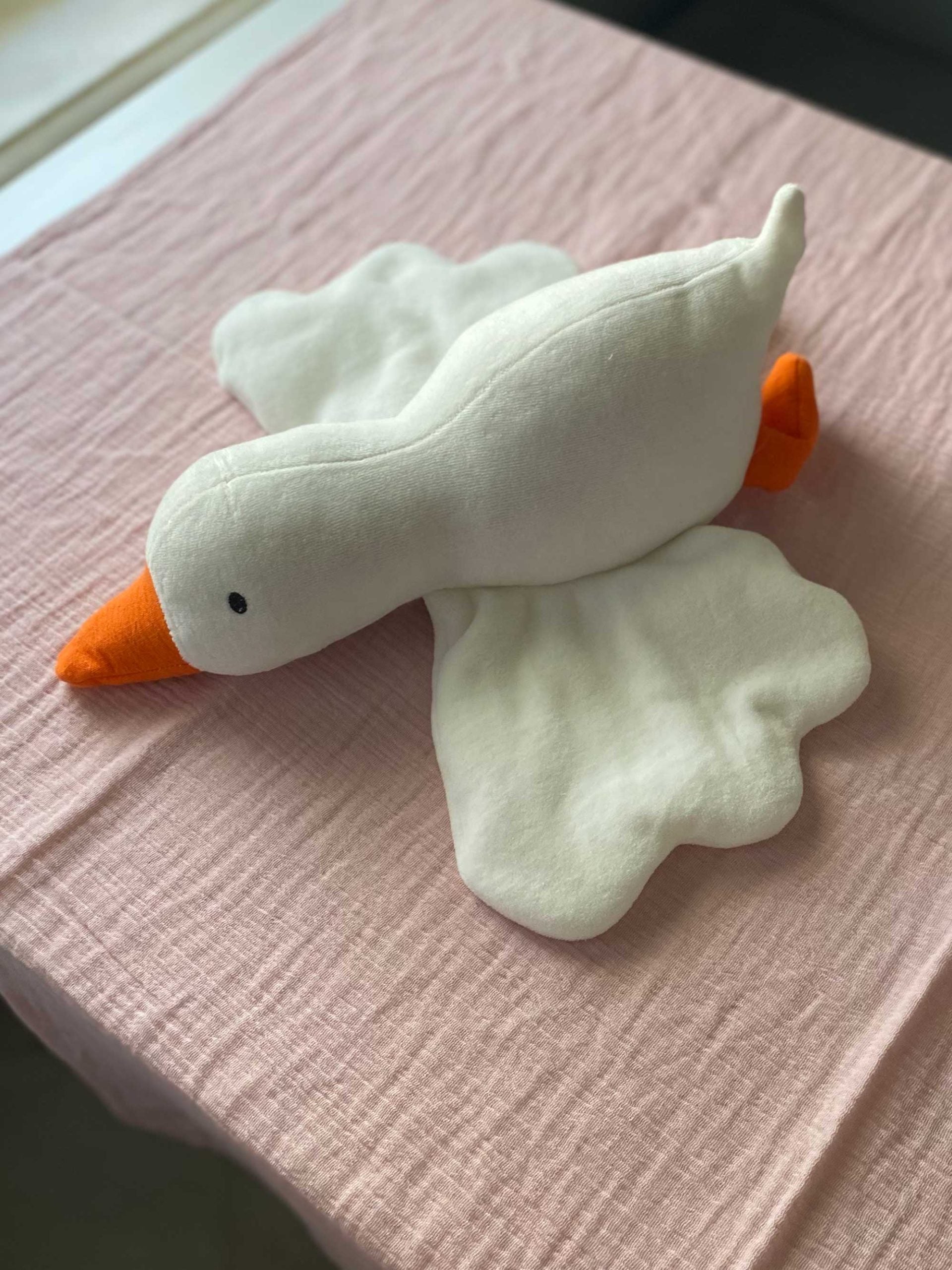 Close-up of Gus the Goose baby plush toy showing soft fabric and shape