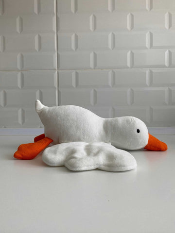 Handmade white goose plush toy with orange beak and feet sitting on flat surface