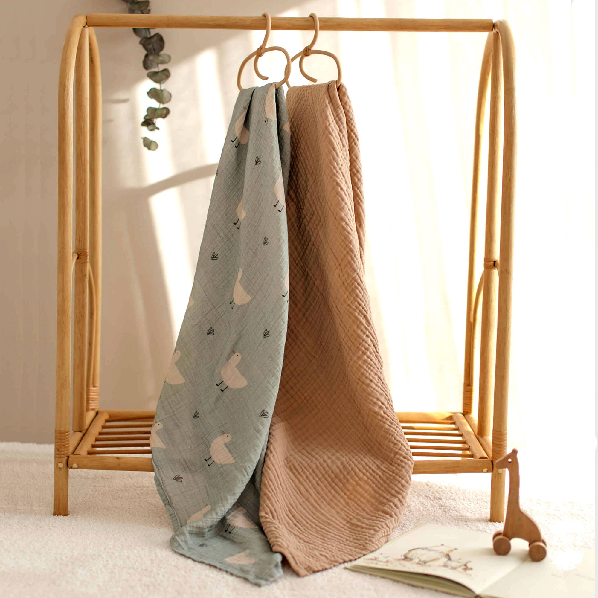 Nursery rack with Minty Duck and latte-colored muslin baby blankets